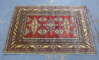 Kazak rug, red field with foliate panels, within multiple hooked borders, 185 x 123cm