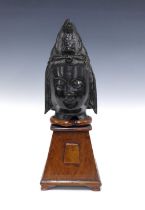 Modern bronze patinated Thai Buddha head on wooden base, 43cm high