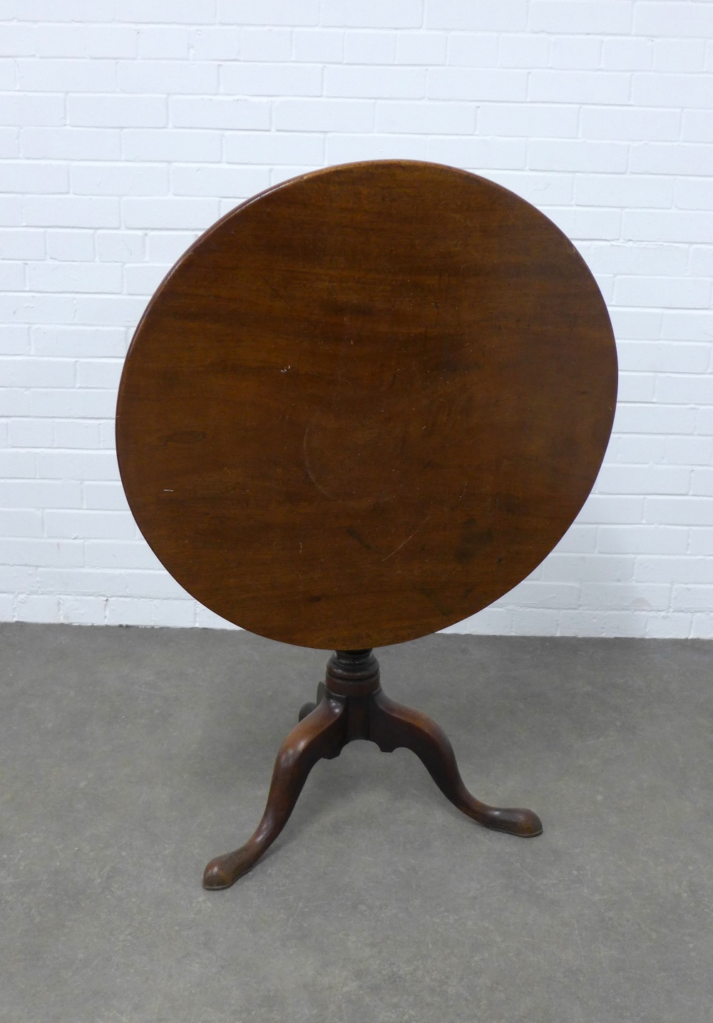 19th century mahogany tilt top table, plain circular top on a pedestal base with splayed legs and