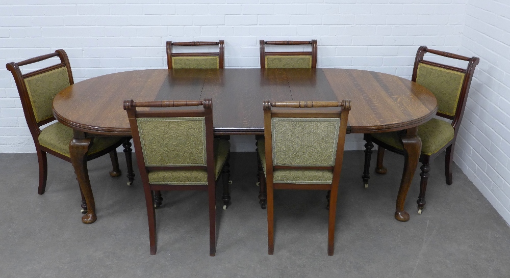 An oak extending dining table and six chairs, 216 x 72 x 107cm. (7)