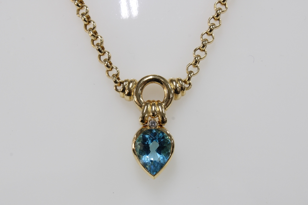 14ct gold pendant necklace set with a pear shaped blue topaz and a round brilliant cut diamond - Image 3 of 4