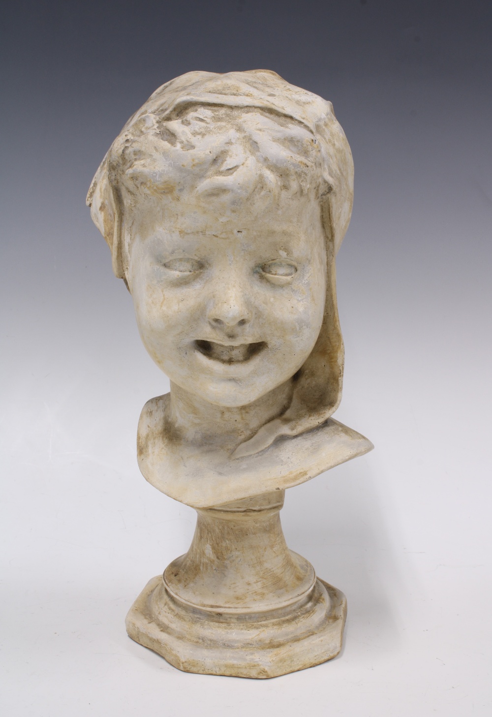Head of a child modelled in plaster on a socle base, 19 x 35cm