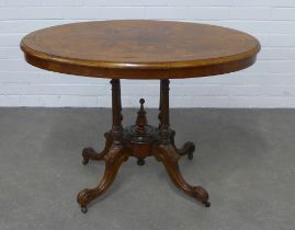 Victorian walnut centre table, quarter veneered oval top table, raised on quadruple turned