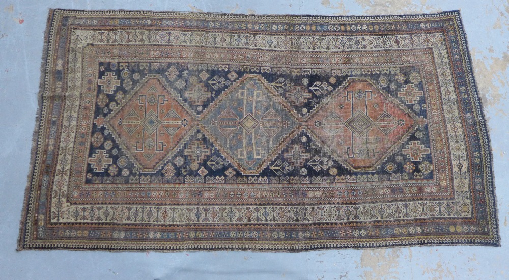 Late 19th / early 20th century Persian rug, three medallions to a blue ground within multiple