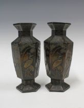 A pair of Japanese bronze patinated metal vases, hexagonal form with relief pattern of storks and