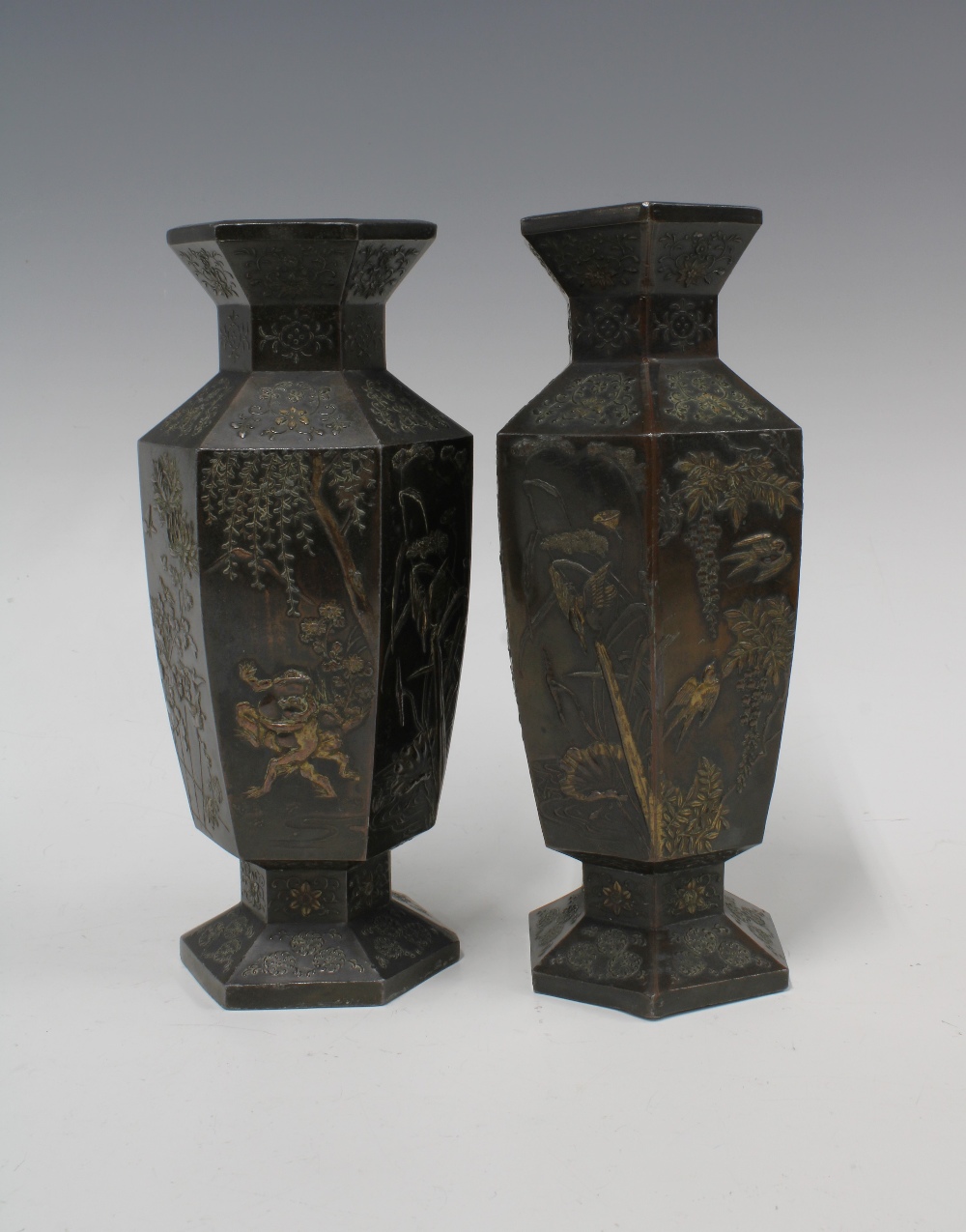A pair of Japanese bronze patinated metal vases, hexagonal form with relief pattern of storks and - Image 2 of 3