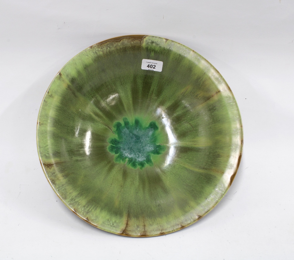 Studio pottery bowl with green streaked glaze, 36cm diameter