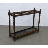 Early 20th century stained pine stick stand, three divisions with original metal drip tray, 87 x