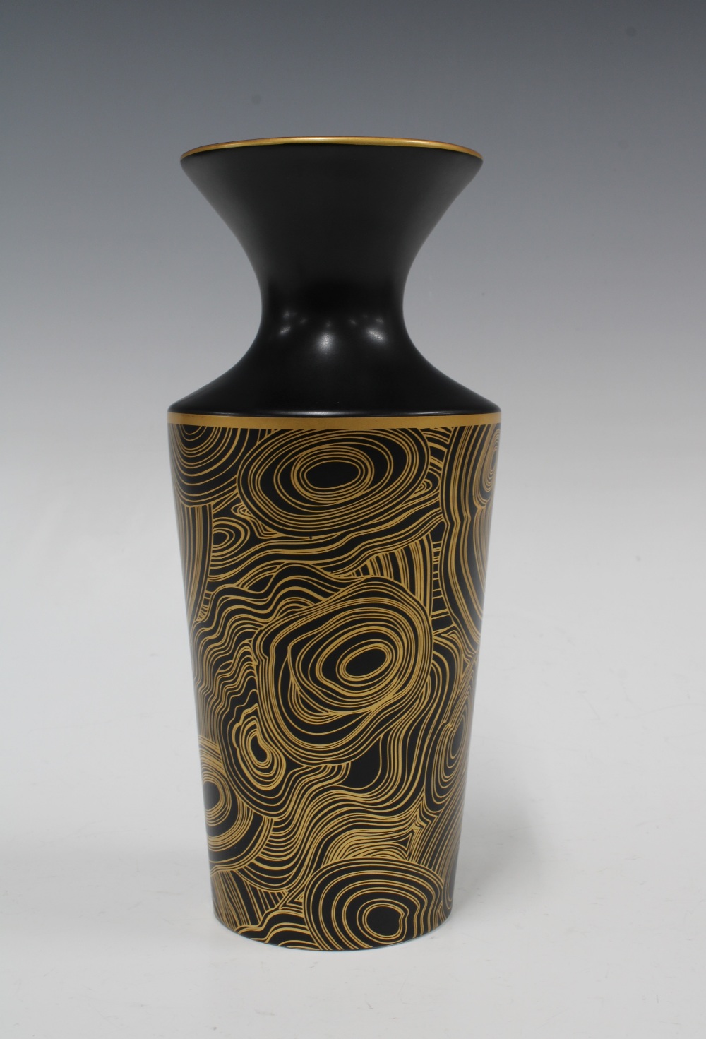 Jonathan Adler vase, black ground with typical gilt swirling pattern, base signed, 23cm