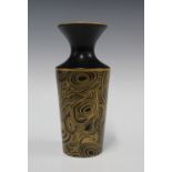 Jonathan Adler vase, black ground with typical gilt swirling pattern, base signed, 23cm