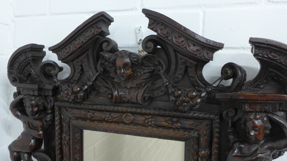 Baroque Revival carved wall mirror, with mask heads, cherubs and broken pediment top, 57 x 65cm. - Image 2 of 3