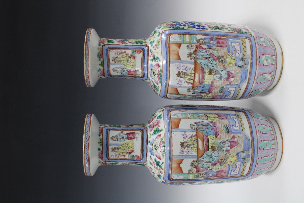 A pair of large Chinese Canton famille rose vases of baluster form, painted with warriors on - Image 2 of 3