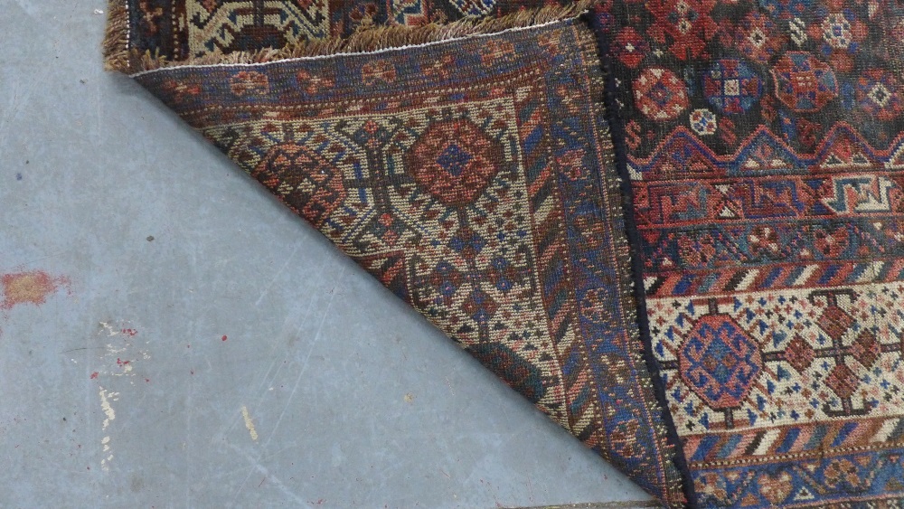 Late 19th / early 20th century Persian rug, three hooked medallions to a foliate ground within - Image 5 of 6