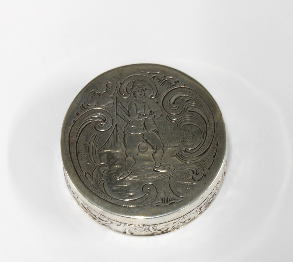 Dutch silver pill box, circular form, hinged lid with an engraved pattern and with repousee side