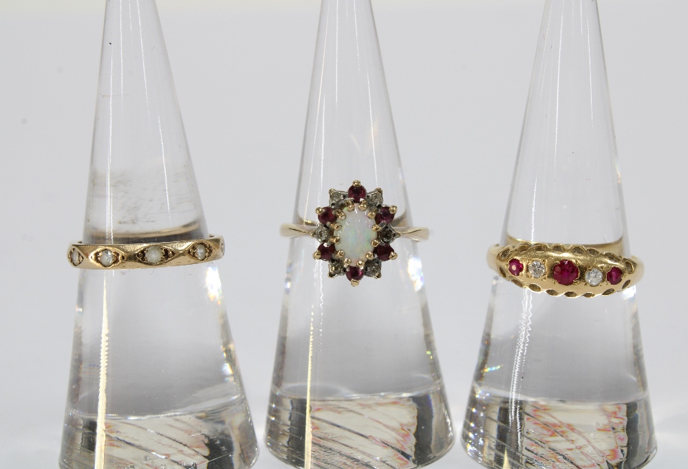 9ct gold opal, ruby and diamond cluster ring, a 9ct gold & diamond set full eternity ring and a ruby