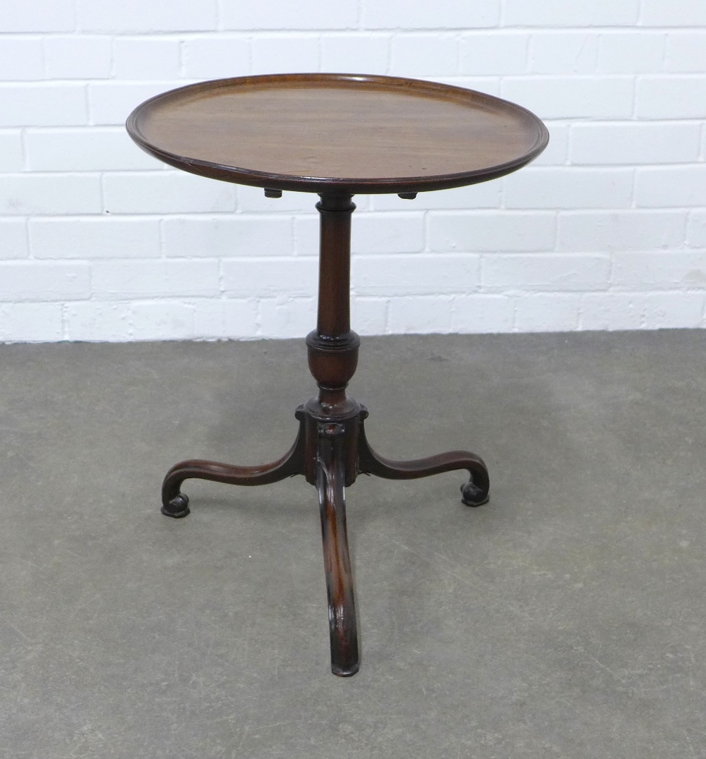 Mahogany tilt top wine table with a circular dished top, on a pedestal base with elegant tripod legs