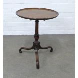 Mahogany tilt top wine table with a circular dished top, on a pedestal base with elegant tripod legs