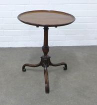 Mahogany tilt top wine table with a circular dished top, on a pedestal base with elegant tripod legs