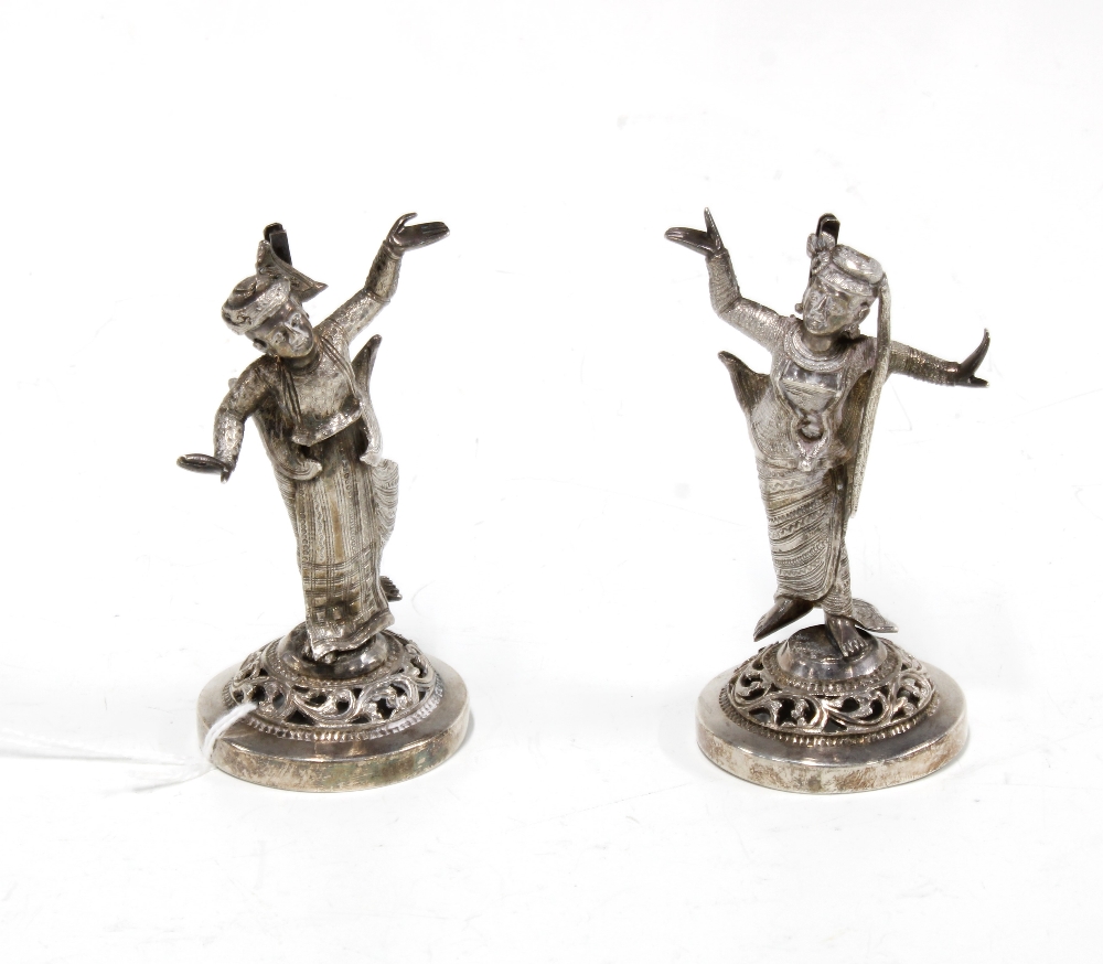Pair of white metal Burmese dancing figures, 8cm high (2)