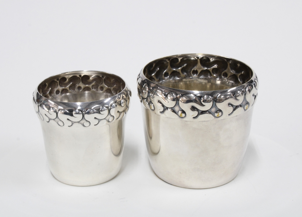 Two Danish silver plated beakers with stylised repoussé rims, he base stamped 'DFA Denmark',