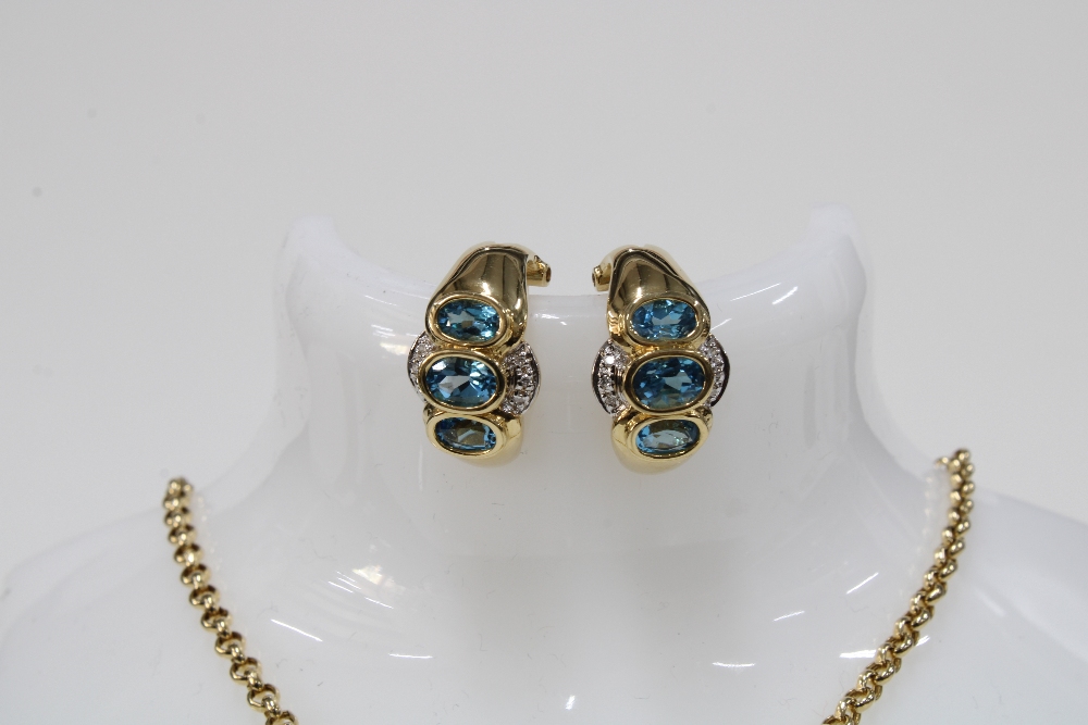 14ct gold pendant necklace set with a pear shaped blue topaz and a round brilliant cut diamond - Image 2 of 4