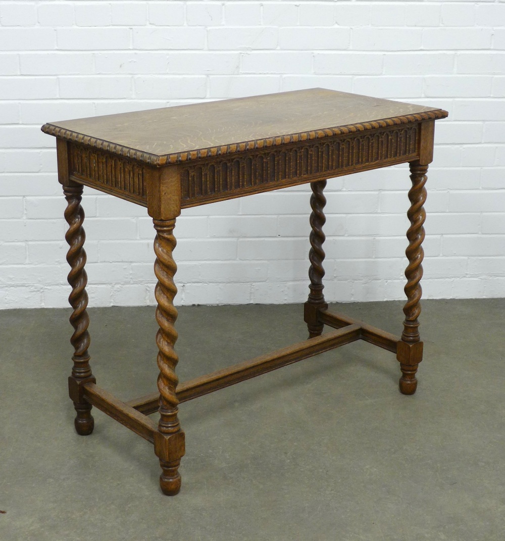 An oak side table with single long drawer, on spiral supports, 88 x 78 x 46cm.