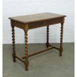 An oak side table with single long drawer, on spiral supports, 88 x 78 x 46cm.