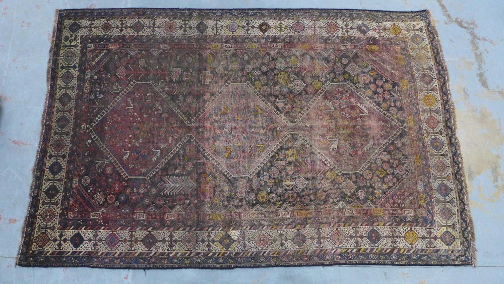 Late 19th / early 20th century Persian rug, three hooked medallions to a foliate ground within