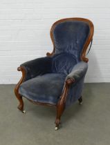 Victorian mahogany framed spoonback armchair with blue upholstery, raised on cabriole legs and