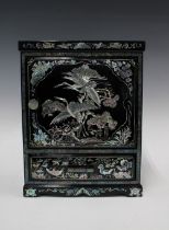 Black lacquered and shell inlaid cabinet, with internal drawers and a long base drawer, 34cm tall
