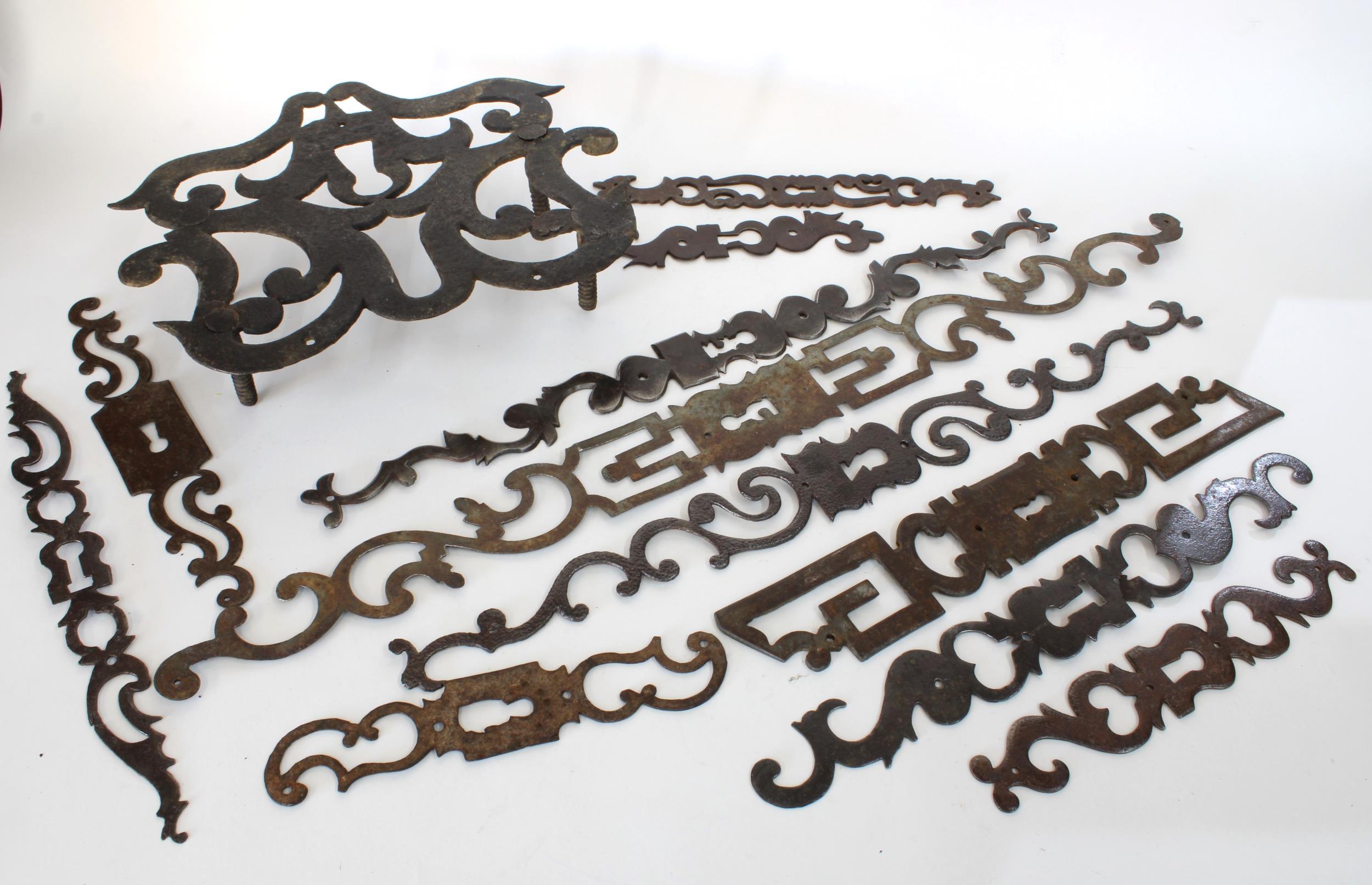 An early trivet and a collection of early escutcheons, (11)