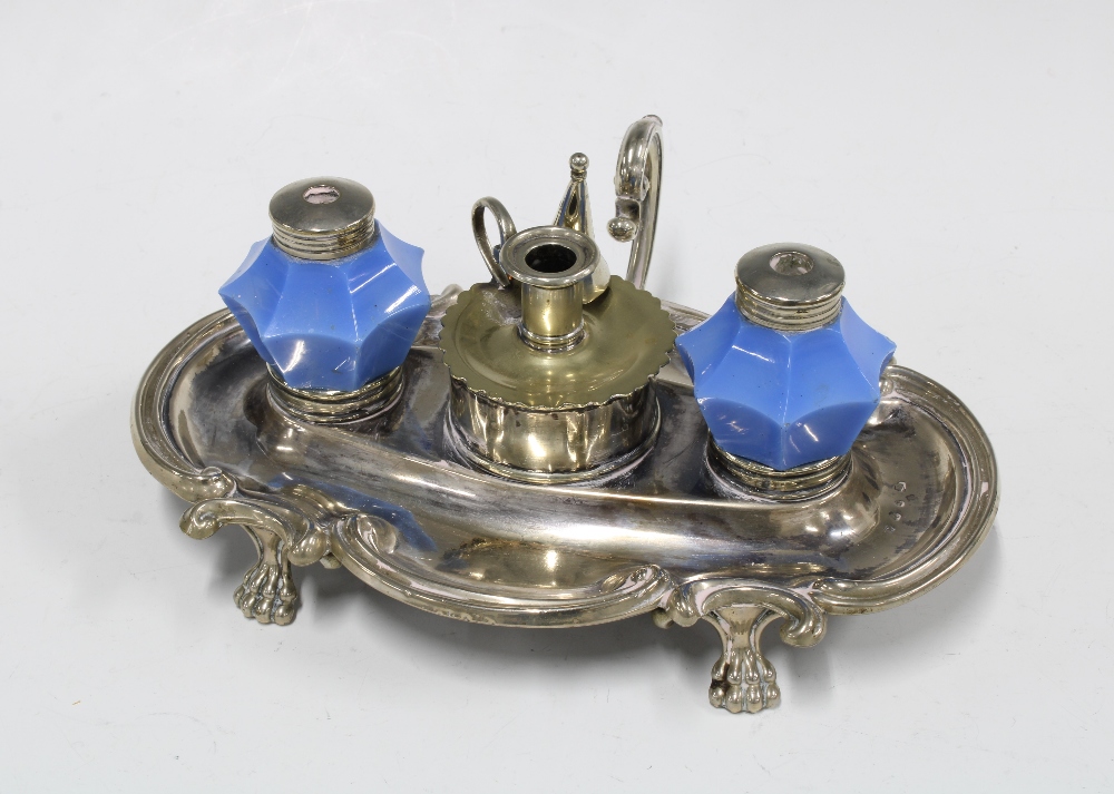 Epns desk inkwell with two blue glass wells and a candle snuffer to centre, standing on paw feet,