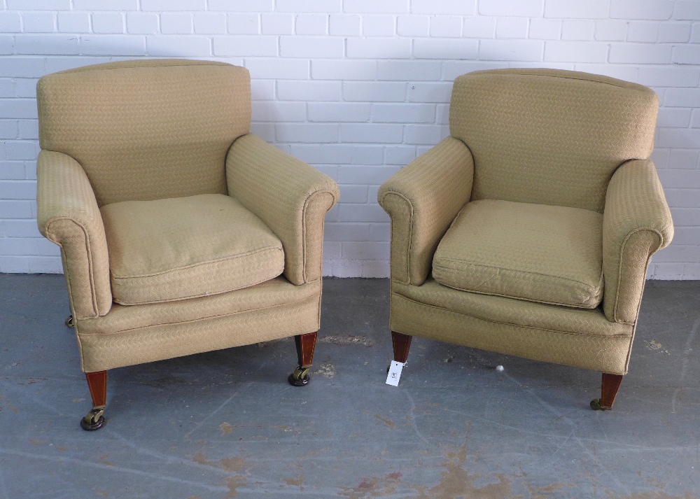 Pair of upholstered armchairs on mahogany legs with brass castors, armchairs, 82 x 83 x 50cm. (2)
