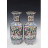 A pair of large Chinese Canton famille rose vases of baluster form, painted with warriors on