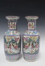 A pair of large Chinese Canton famille rose vases of baluster form, painted with warriors on