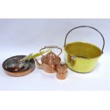 A collection of copper and brass pans, a vintage brass jelly and and a small copper canister and