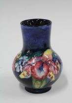 Moorcroft Orchid pattern vase, blue ground with impressed factory marks, 9 x 13cm.