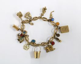 18ct gold bracelet with a quantity of charms to include five 9ct gold examples
