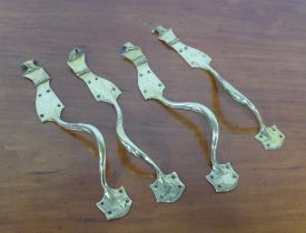 Four Art Nouveau brass handles, 45cm. (4)