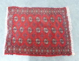 Bokhara rug, red field with three rows of seven guks, 110 x 89cm.