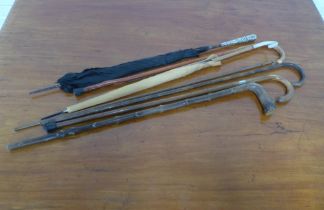 Collection of malacca and other walking canes, two parasols, etc.