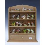 A collection of 20 Beswick pottery bird figures together with a shelved wall display rack
