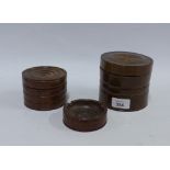 Two turned wooden jars and covers and a matching ashtray (3)