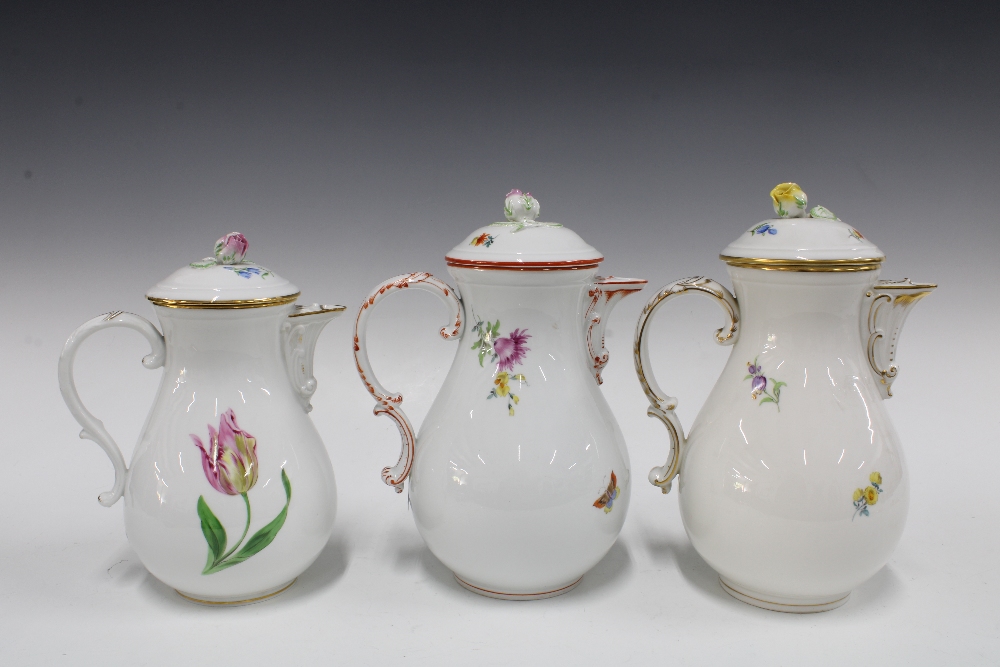 Three Meissen coffee pots of baluster form and painted with flowers, each with a rosebud finial ( - Image 2 of 3
