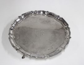 Edwardian silver salver, pie crust edge and engraved initials to centre, Sheffield 1910, standing on