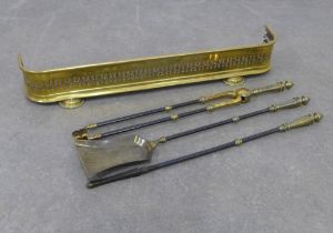 Three part fireside companion set and a pierced brass fender, 77cm. (4)