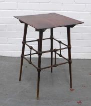 Manner of E. W. Godwin (British, 1833-1886) mahogany side table, square top standing on turned