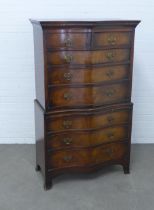 Mahogany reproduction serpentine chest on chest, the base with a pull out slide, 89 x 152 x 49cm.