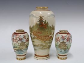 A garniture of Japanese earthenware vases, with pagoda pattern and signed with character makrs, to