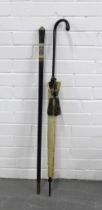 Ebonised sword stick with a brass mounted faux ivory handle and an early 20th century parasol (2)
